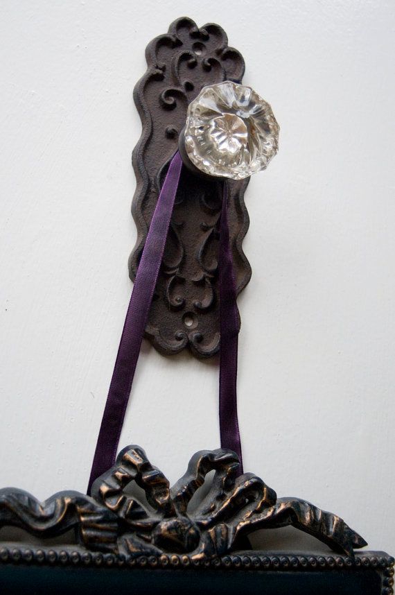 Use vintage or antique door knobs to create visually striking photo holders and hangers.