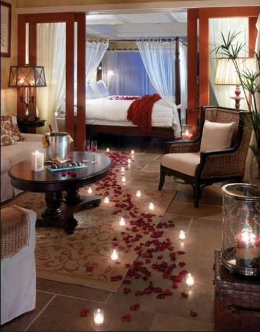 The petals path with the candles lighting the way towards the bed is incredibly romantic. Image Source: Pinterest