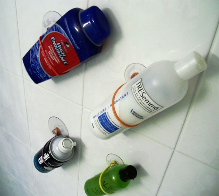 With some cheap suction cups and elastic bands, you can create bottle holders!