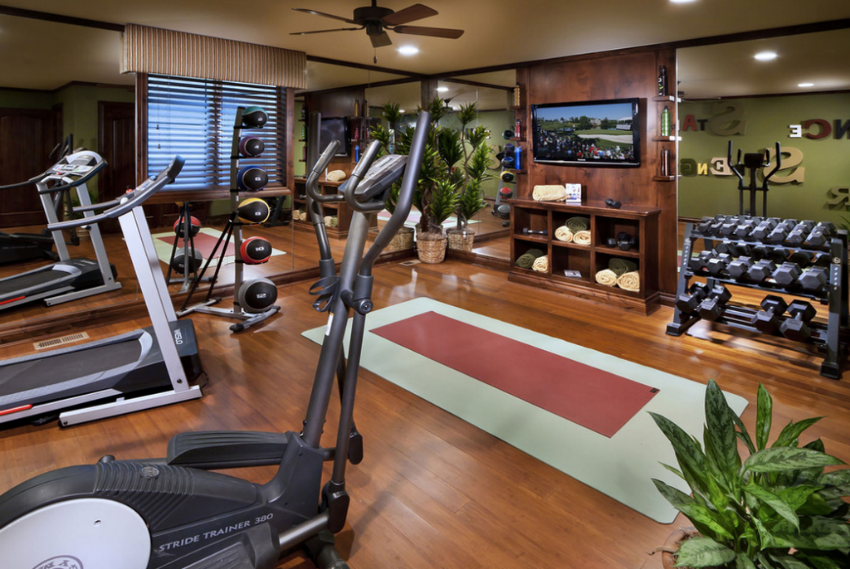 This is a traditional decor home gym but the equipment is state-of-art. Image Source: Homes Of The Rich