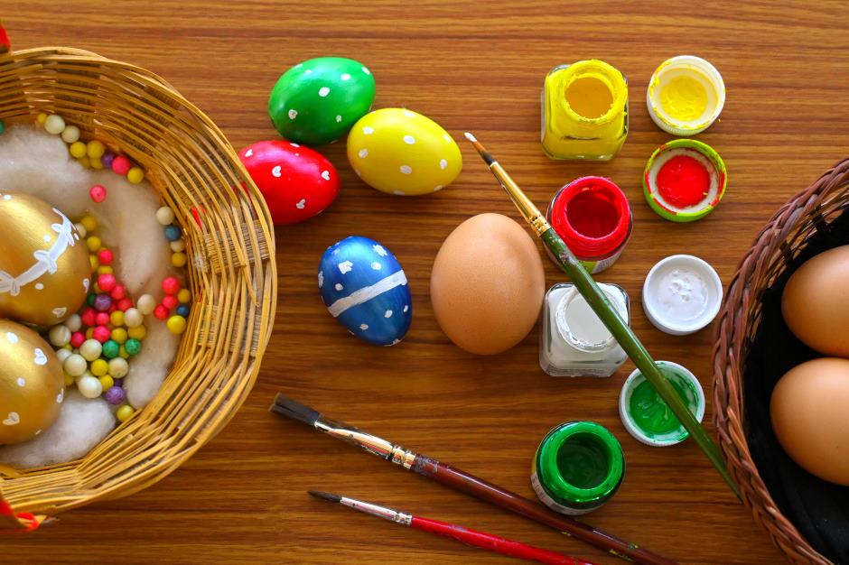 Several eggs decorated with an Easter theme on a wooden table